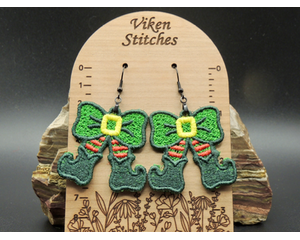 Cute machine embroidered earrings -elf legs and green boots with a green bow with a yellow buckle as the body. Black hypoallergenic hooks.